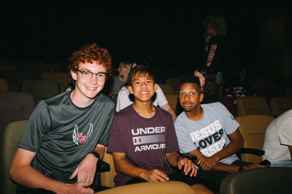 Students enjoying Oneighty youth service at a church in Tulsa focused on helping the next generation grow through Bible teaching.