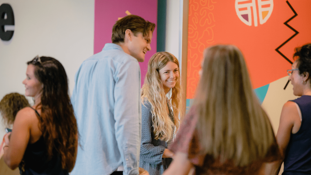 Young woman being welcomed at a New Here Gathering, a space to grow in community at Church on the Move Tulsa.